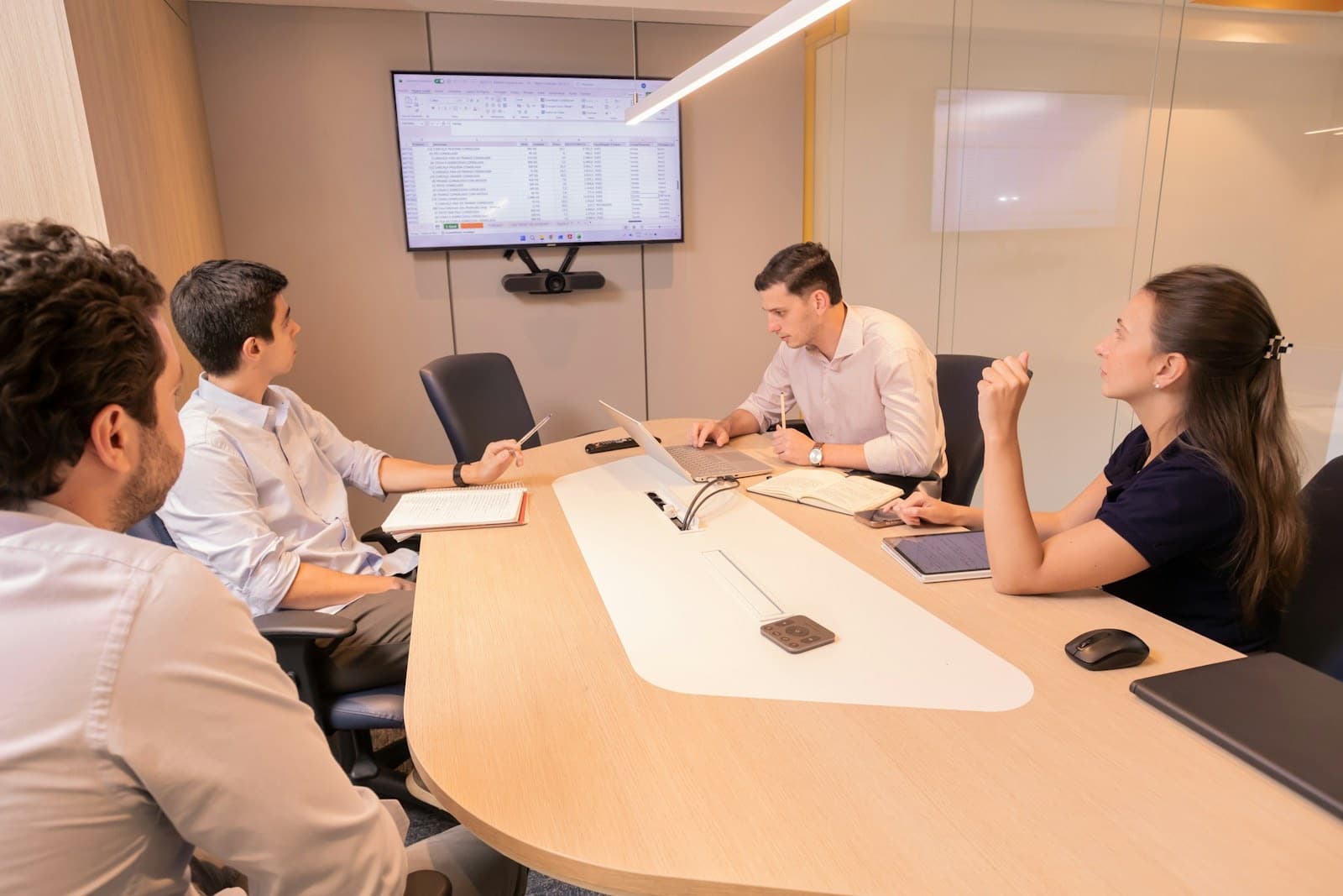 A management team meeting around a table planning a buy-out