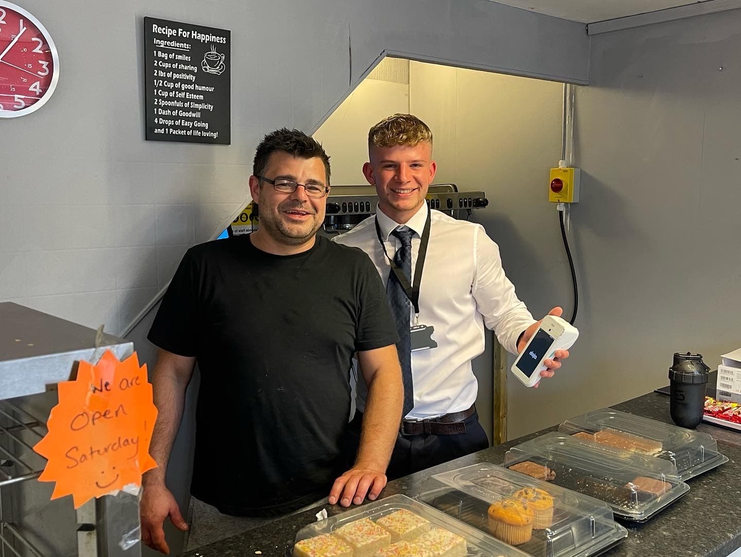 Café owner receiving a new Dojo terminal from a CapExpand representative