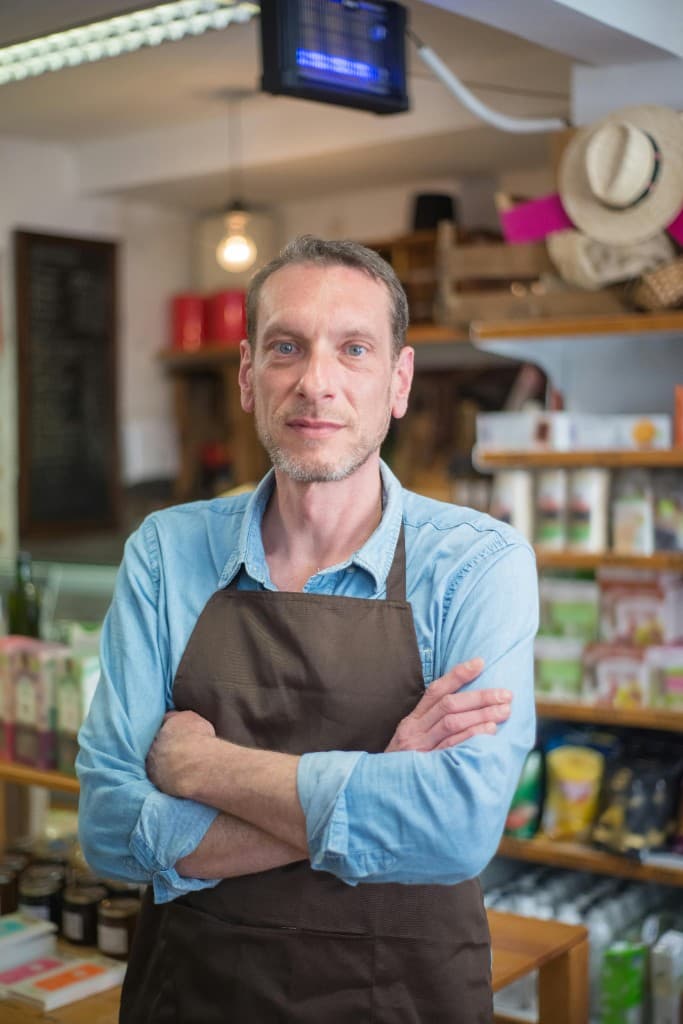 Independent shop owner standing in his business
