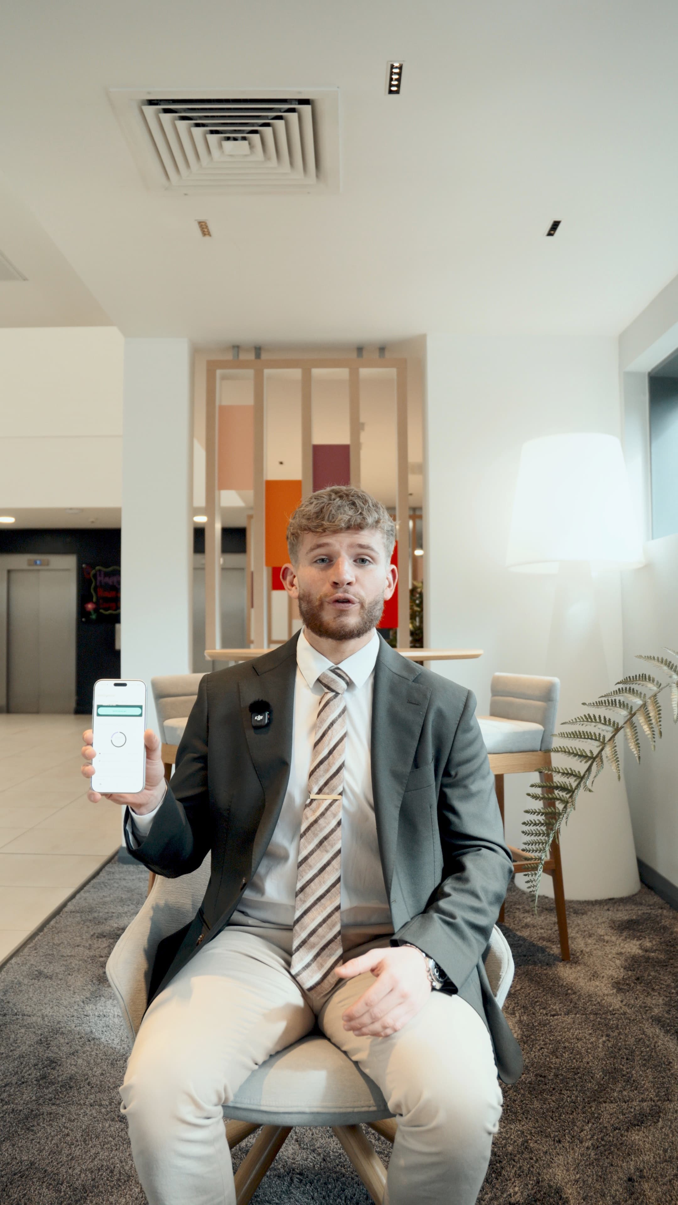Alex showing a client the takings dashboard on a phone