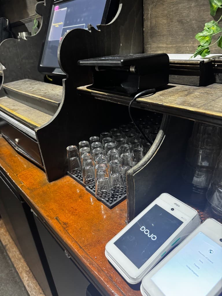 Two Dojo terminals on the bar counter beside the till point