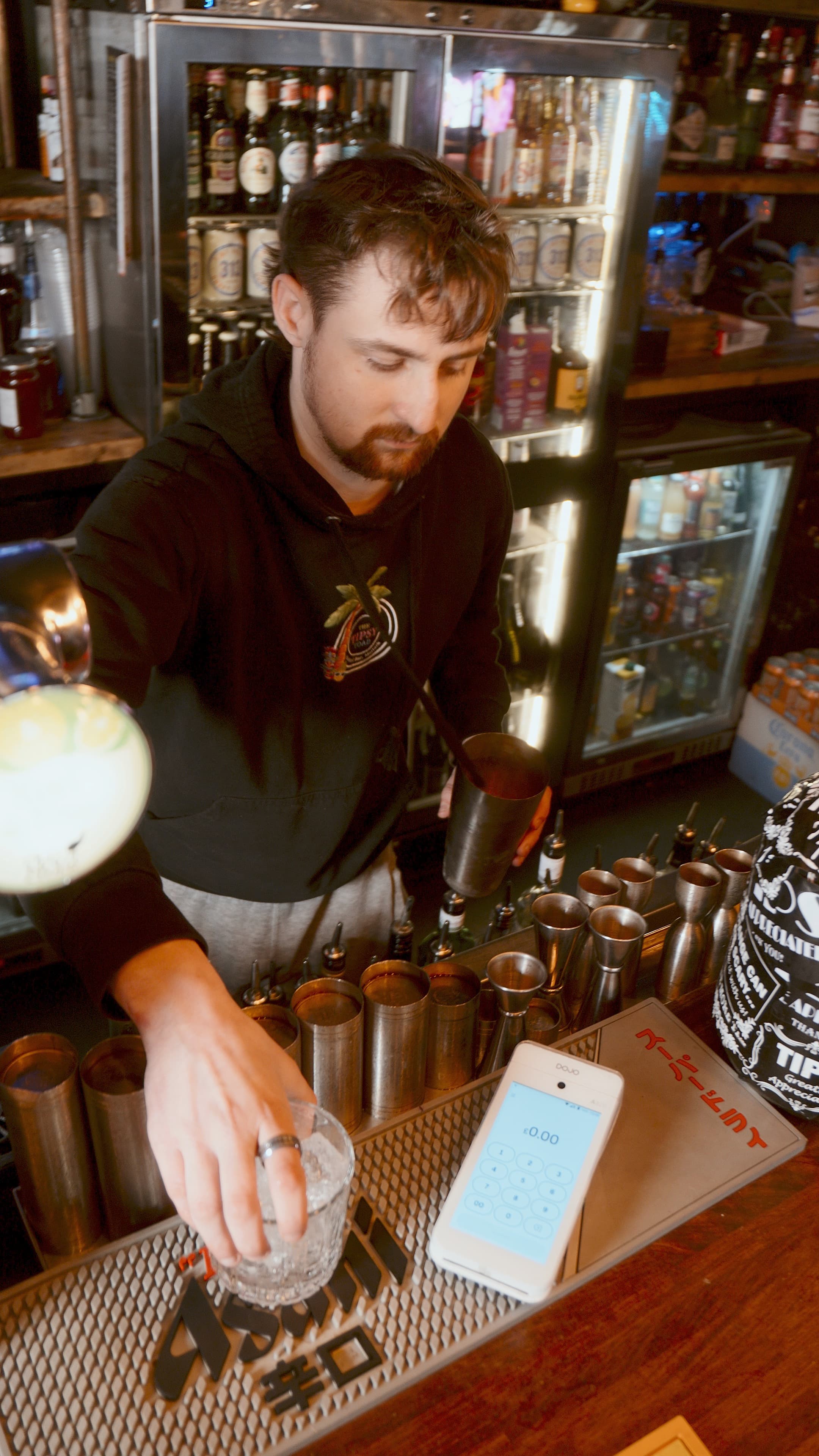 A bartender making drinks at one of our bar clients