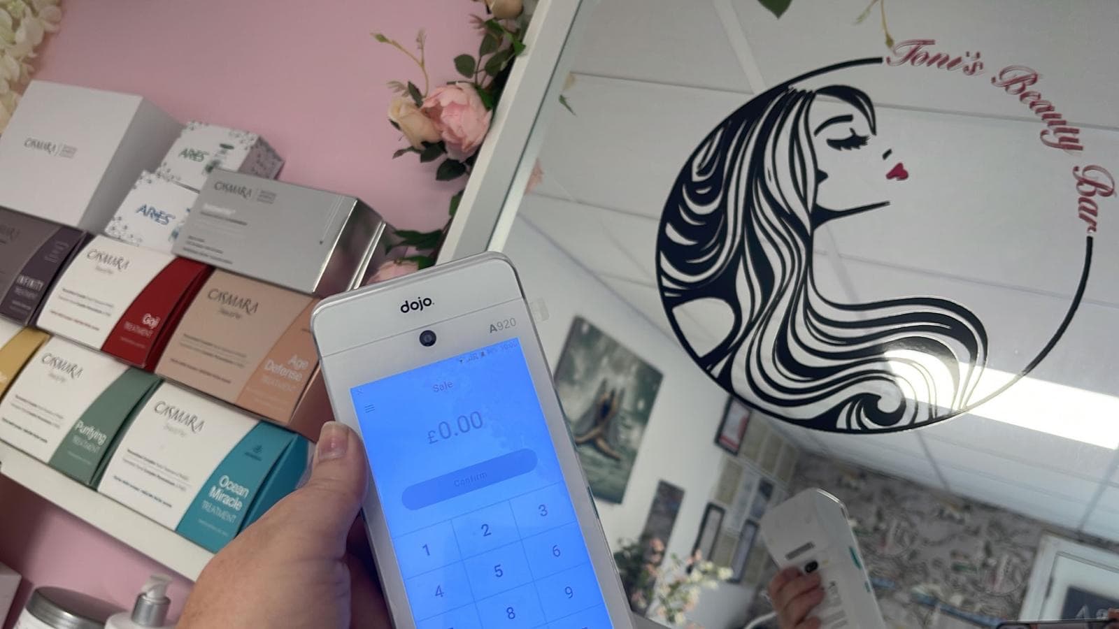 Beauty salon owner taking a card payment at her desk