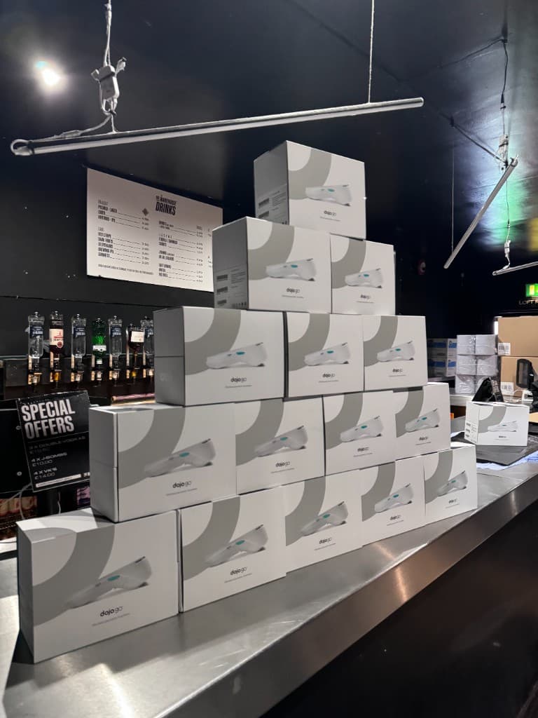 Dojo terminal at The Warehouse bar with colourful mural